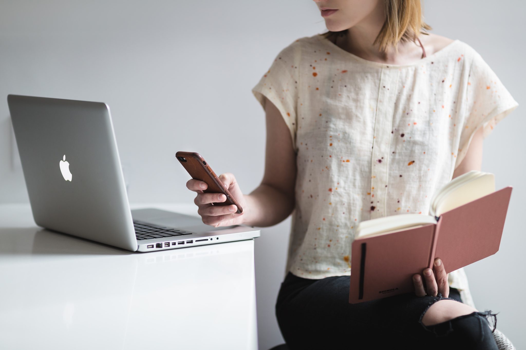 Woman using apps for online real estate course.