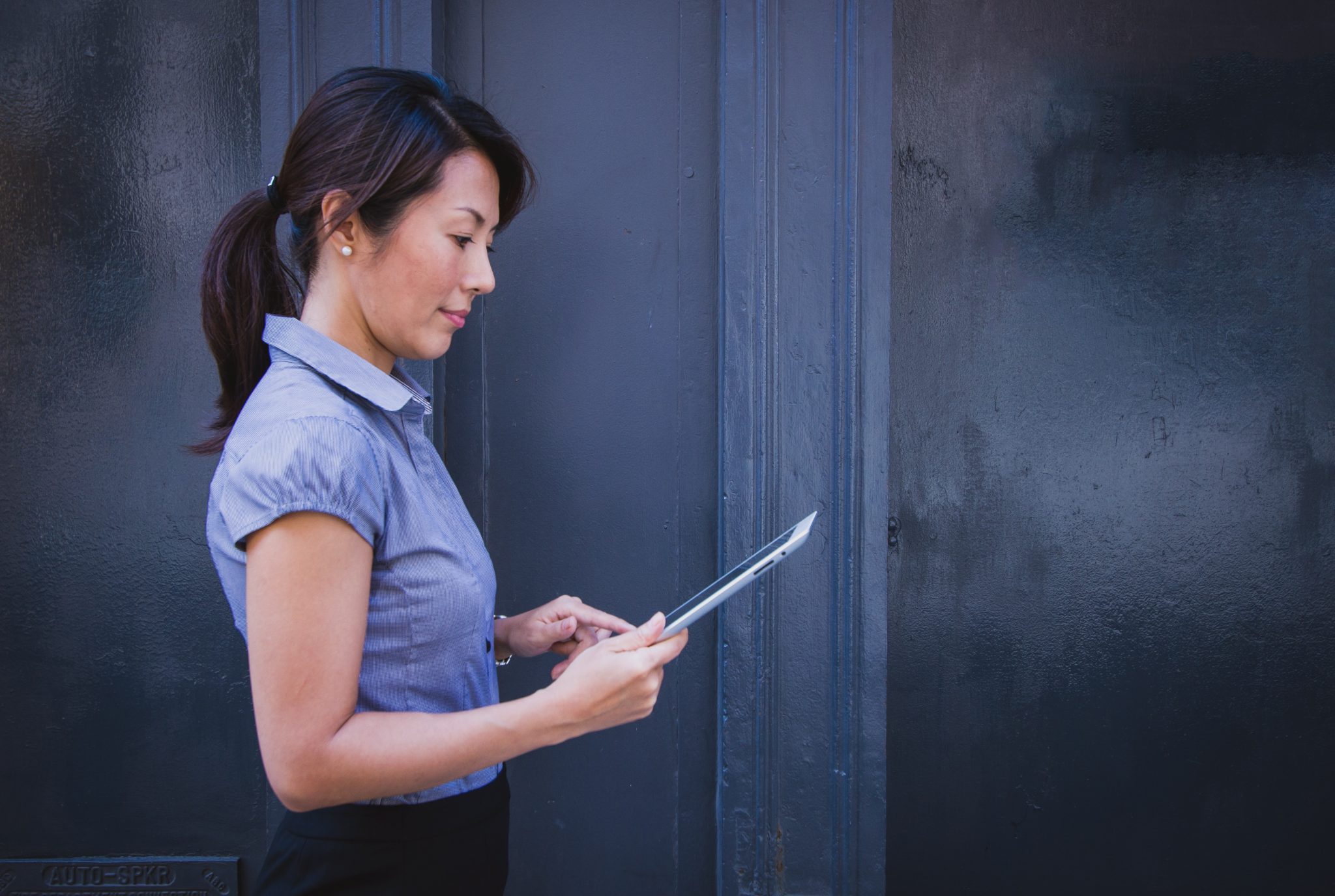 A woman holding forms about the Louisiana insurance license requirements.