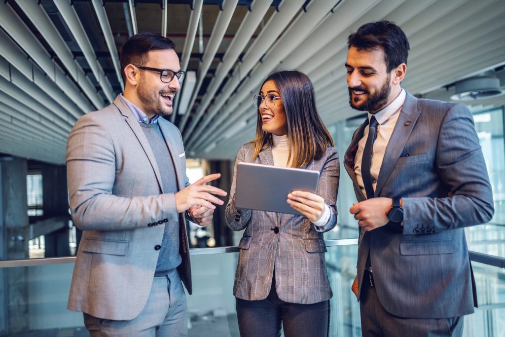 Professionally dressed real estate agents networking and mentoring each other