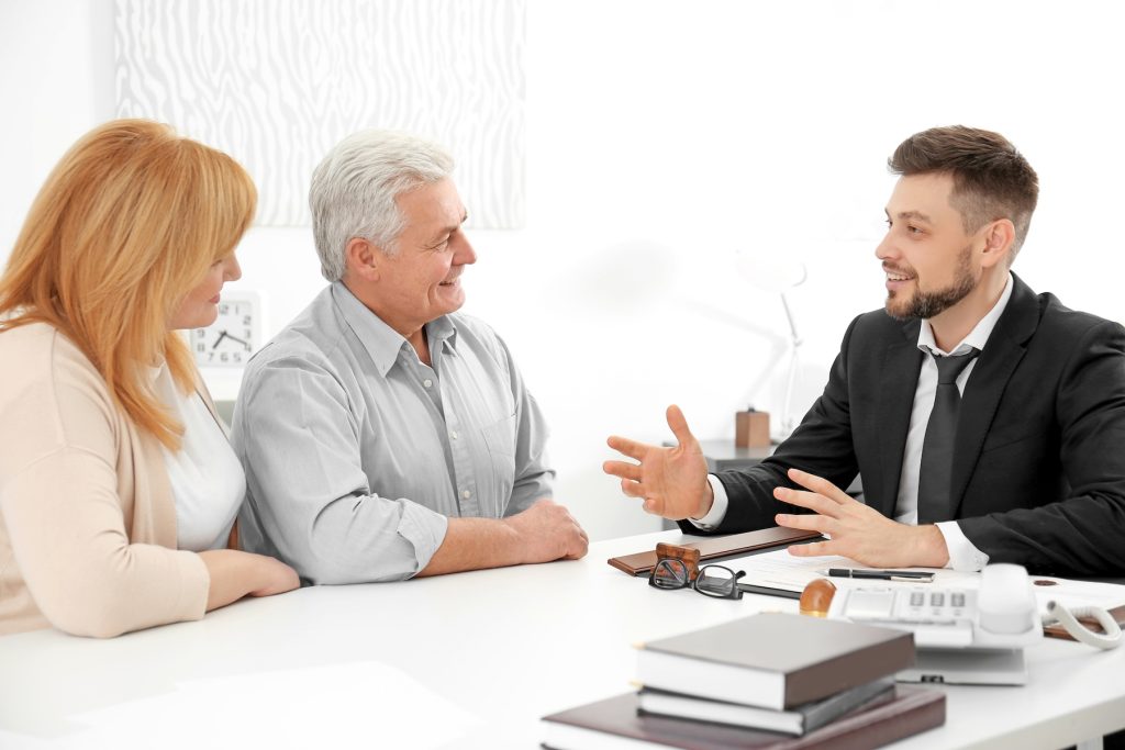 Senior couple meeting with a young male insurance agent