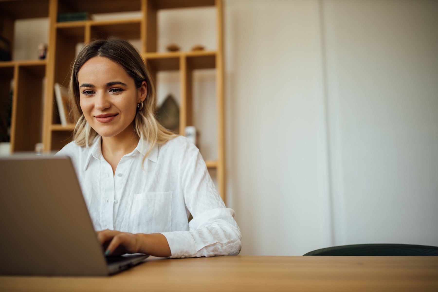 Young woman working on laptop at home office