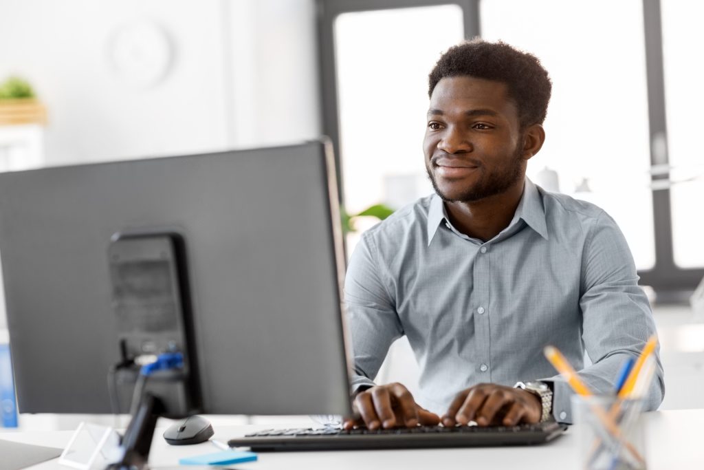 African American businessman with computer working at office